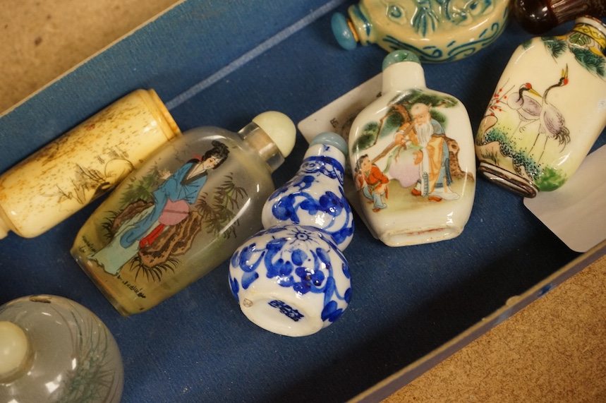 A group of Chinese snuff bottles to include porcelain, bone, enamelled, glass and amber examples, tallest 8cm. Condition - varies